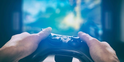 Gaming-Controller wird vor einen Bildschirm gehalten