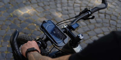 Smartphone befindet sich in einer Halterung am Fahrrad.