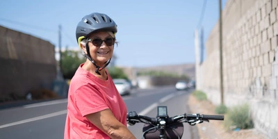 Eine Frau ist glücklich mit ihrem E-Bike