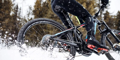 Person fährt auf E-Bike durch den Schnee