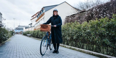 Frau steht neben Fahrrad