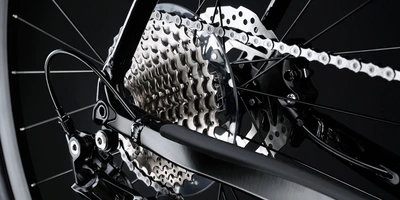 Detaillierte Nahaufnahme einer Fahrradkette und Ritzel in Schwarz und Silber.