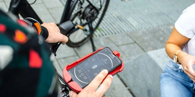 Smartphone befindet sich in einer Halterung am Fahrrad.