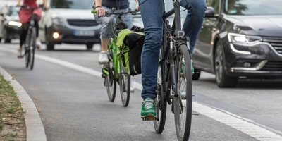 Mit dem Rad zur Arbeit und somit Sprit sparen Personen fahren mit ihrem Rad zur Arbeit
